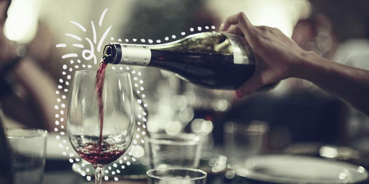 Woman pouring a glass of red wine in singapore